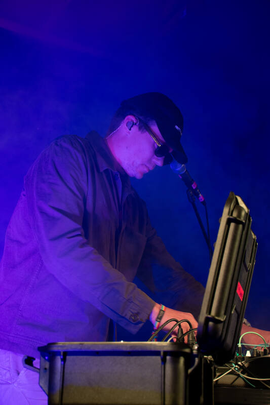 Andreas at the modular synthesizer, lit in blue